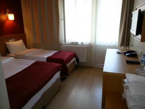 Postel nebo postele na pokoji v ubytování Cetinkaya Hotel