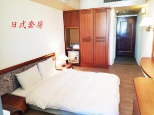 Posteľ alebo postele v izbe v ubytovaní Hsinchu Shih business hall
