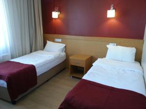 Postel nebo postele na pokoji v ubytování Cetinkaya Hotel