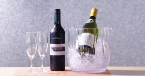 a bottle of wine and two wine glasses on a table at Umiakari in Himi