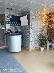 een keuken met een aanrecht en een stenen muur bij Hotel Belisimo in Ruse