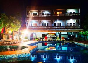a hotel with a swimming pool in front of a building at Southern Star Resort in Pattaya North