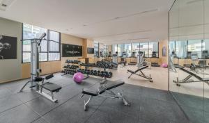 a gym with treadmills and exercise equipment in a building at Seda Bonifacio Global City in Manila