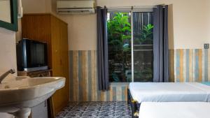 Postel nebo postele na pokoji v ubytování Sabina Guesthouse Kamala