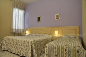 Postel nebo postele na pokoji v ubytování Hotel Regina + 14 fotografií