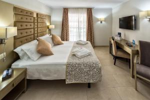 a hotel room with a large bed and a television at Hotel Soho Boutique El Tiburon & Spa -Adults Recommended in Torremolinos