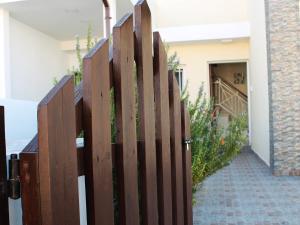 a wooden fence in front of a house at Panorama Beach House, 5 meters to the sea in Pervolia