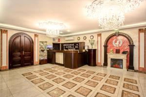 a lobby with a fireplace and chandeliers at Privilegia in Saint Petersburg
