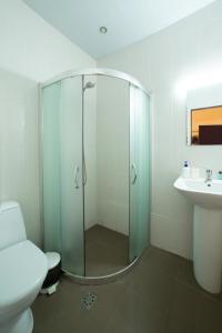 a bathroom with a shower and a toilet and a sink at Saryan Hotel Yerevan in Yerevan