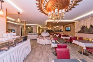 a restaurant with tables and chairs and a chandelier at VERSİON HOTEL in Istanbul