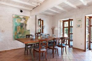 a dining room with a wooden table and chairs at Studios Kyparissi & Spa in Tyros