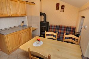 a kitchen with a wooden table and a stove at Ekološka turistična kmetija pri Lovrču in Tolmin