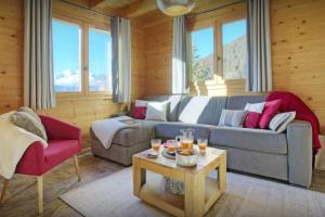 a living room with a couch and a table at Chalet Tekoa - OVO Network in Manigod