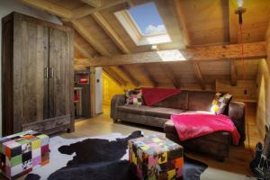 a living room with a brown couch and a window at Chalet Artedaz - OVO Network in La Clusaz