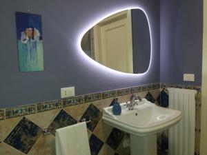 a bathroom with a sink and a mirror at Suite Saragozza Free small Parking,Bologna in Bologna