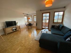 a living room with a couch and a flat screen tv at Ferienwohnung Füsin in Berchtesgaden