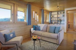 a living room with a couch and two chairs at Chalet Tekoa - OVO Network in Manigod