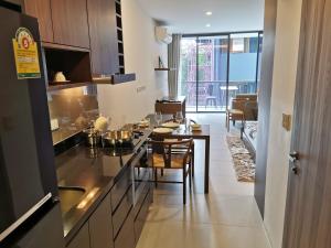 a kitchen with a table and a dining room at Escape Condominum E125 in Mae Pim