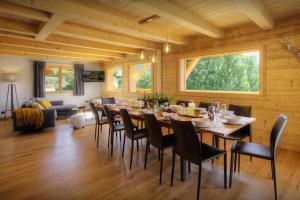 a dining room with a long table and chairs at Chalet Marinaka - OVO Network in Manigod