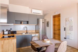 a kitchen with a wooden table and a dining room at Sophia's Beach House in Lévktron