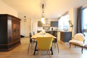 a kitchen and dining room with a table and chairs at Colmar City Center - Bright and Large Appartement REMPARTS in Colmar