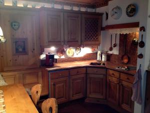 a kitchen with wooden cabinets and a table at Appartement Schuricht in Reit im Winkl