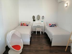 a room with two beds and a table with mirrors at Apartment Lana in Šilo