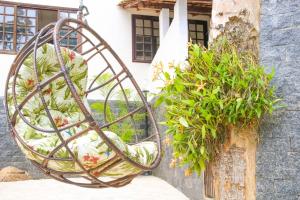 a hanging basket with plants in it next to a building at Casa Pedra Bonita in Rio de Janeiro