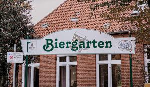 a sign for a beer garden in front of a building at Gasthof-Hotel Biedendieck in Warendorf