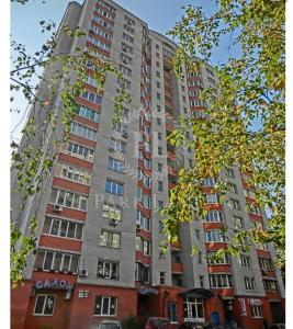 a tall apartment building with many windows on it at Затишна 2х кімнатна квартира біля метро Академмістечко in Kyiv