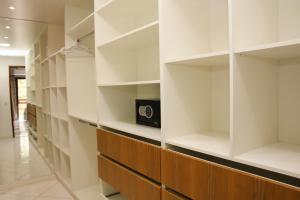 a walk in closet with white walls and wooden shelves at Casa Pedra Bonita in Rio de Janeiro