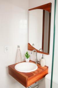 a bathroom with a sink and a mirror at Casa Pedra Bonita in Rio de Janeiro
