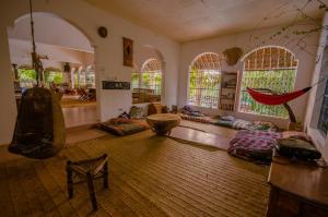 a living room with a hammock in the middle of it at Distant Relatives Ecolodge & Backpackers in Kilifi