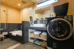 a bathroom with a washing machine and a sink at No.8 Kyoto in Kyoto