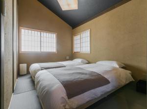 Säng eller sängar i ett rum på No.8 Kyoto