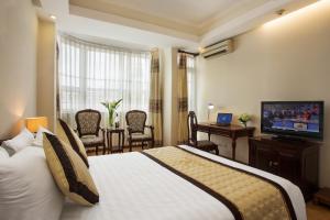 Giường trong phòng chung tại Camellia Boutique Hotel & Spa