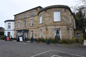 an old brick building on the corner of a street at The Mount by Greene King Inns in Wigan