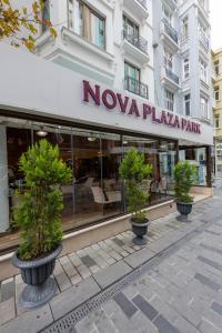 a nova plaza park with trees in pots in front of a building at Nova Plaza Park Hotel in Istanbul
