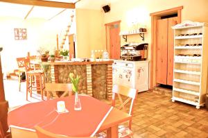 a kitchen with a table and chairs and a counter at Maciejowa Chata in Pobiedziska +12 photos