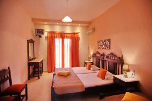 a bedroom with a bed and a table and a window at Maria Studios in Neo Klima