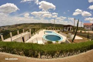 a swimming pool in the middle of a yard at Chalé Serra Nevada - Bananeiras in Bananeiras