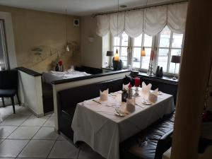 a dining room with two tables in a restaurant at Hotel & Ristorante Il Duomo in Olpe