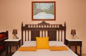 a bedroom with a bed with a yellow pillow on it at Maria Studios in Neo Klima