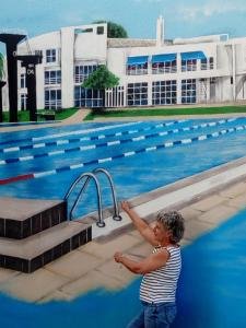 a young child standing next to a swimming pool at Casa da Cidade de Loule in Loulé