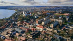 an aerial view of a city next to a body of water at Telšių Hotel in Telšiai