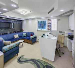 a living room with a blue couch and a kitchen at OBAHAN HOTEL-Special Class in Istanbul