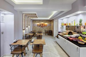 a restaurant with wooden tables and chairs and a counter at OBAHAN HOTEL-Special Class in Istanbul