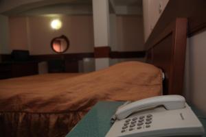 Ένα ή περισσότερα κρεβάτια σε δωμάτιο στο Hotel Cingo