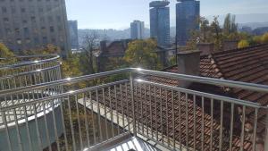 a metal balcony with a view of a city at Apartment Esha in Sarajevo