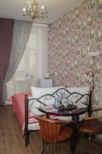 a bedroom with a bed and a table with a tableasonable at Hotel Tverskaya 5 in Moscow